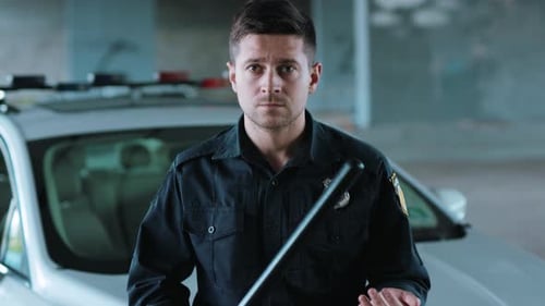 Serious Young Man Cops Stand Near Patrol Car Look at Camera Enforcement Background His Colleague
