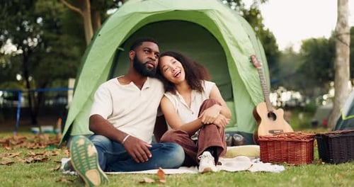 Loving Couple Camping Together in a Grassy Field