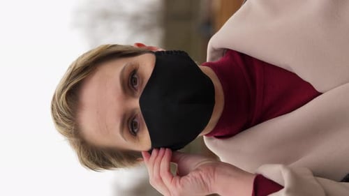 Young woman in black face mask for health safety during coronavirus pandemic outdoors