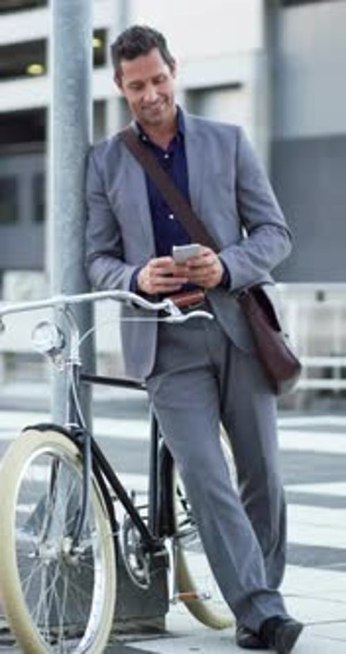 Businessman, phone and texting with bicycle in city for commute, smile and notification on web