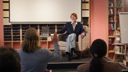 Woman Giving Speech to Small Audience Indoors
