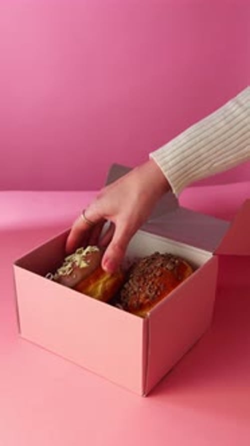 Woman Takes Glazed Donut from Pink Box