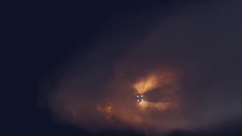 Rocket booster separation and stage ignition during a space mission launch.