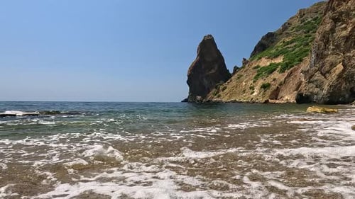 Small Sea Wave Blurred Soft Foamy Waves Washing Golden Sandy Beach and Volcanic Rocky Shores Nobody