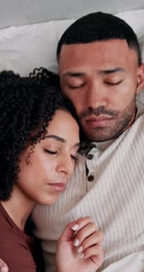 Couple Sleeping Peacefully Together in Bed