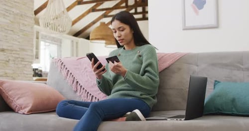 Woman Shopping Online with Phone and Credit Card