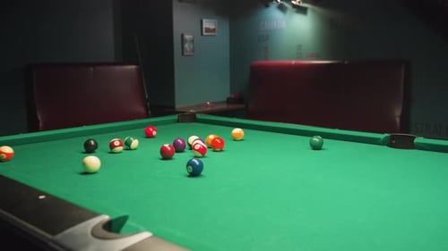 Billiard Balls Scattered Across Pool Table After Powerful Break Shot