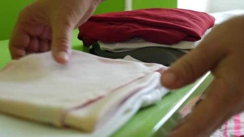 10. The woman carefully puts the clothes in the closet. Homework. Washing, ironing and folding cloth