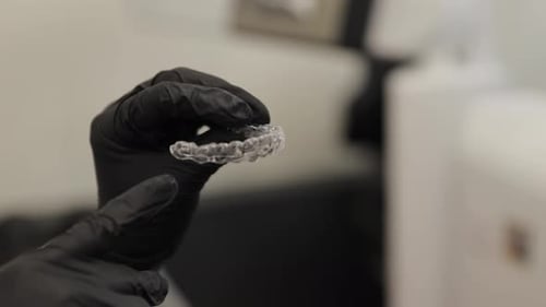 Orthodontist Holding Invisible Dental Braces Aligner