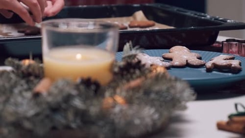 A Feminine Hand Places Freshly Prepared Ginger Cookies on a Turquoise Plate