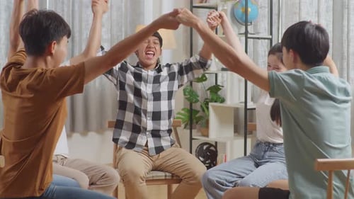 Group of Young Adults Holding Hands in Circle