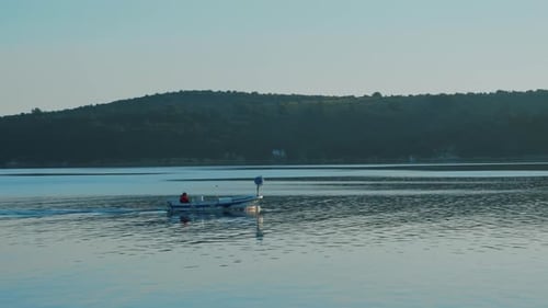 Lone Boater Sailing on Open Water