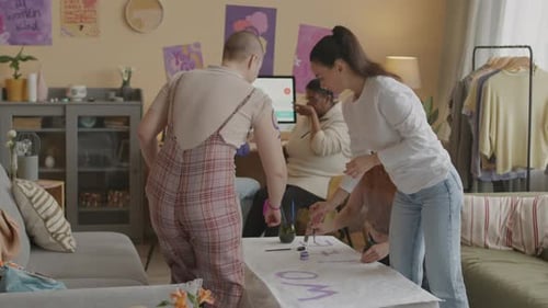 Multiethnic Feminist Team Preparing for Protest at Home