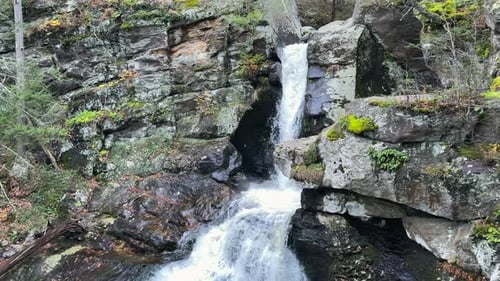 A waterfall cascades down a rock’s crevice