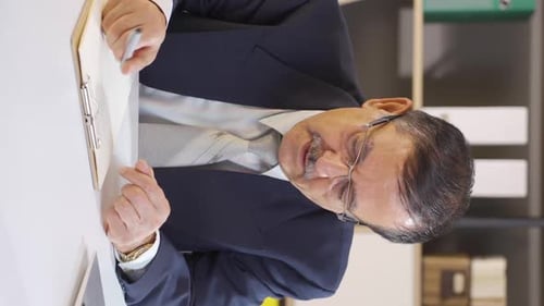 Vertical video of Overwhelmed businessman daydreams.