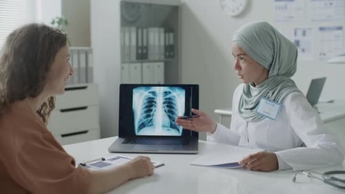 Doctor Explains Chest X-Ray to Patient in Office