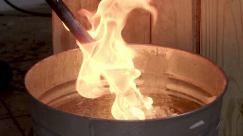 Glowing Red Hot Metal Rod Plunged into Water