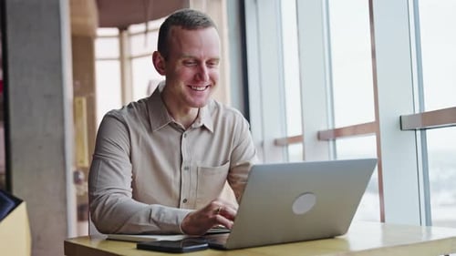 Man Using Laptop in Modern Office Space