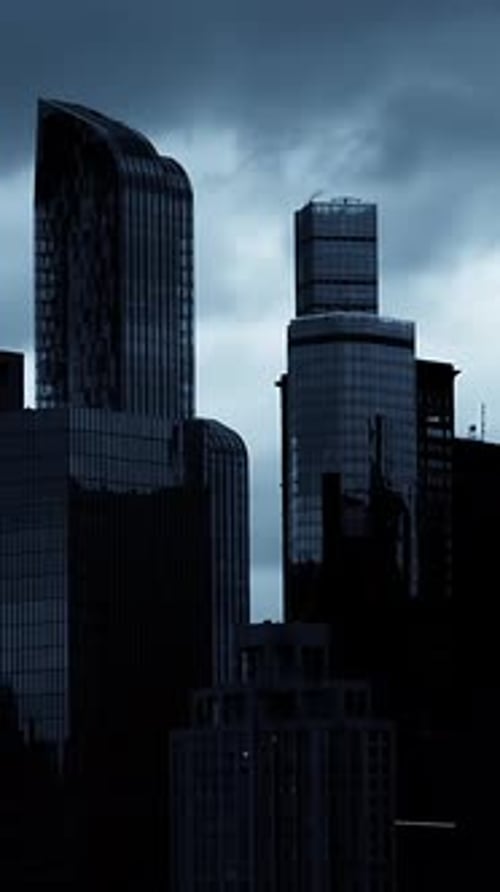 Dark Cityscape with Tall Buildings at Night
