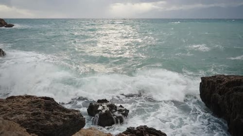 Large Waves Crash Against the Rocks, and Splashes Soar Towards Me, a Maritime Storm. In Slow Motion.