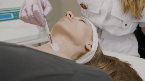 Woman Receiving Facial Cosmetic Treatment in Clinic