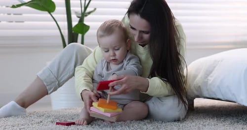 Woman and Infant Playing with Colorful Toy Stacker