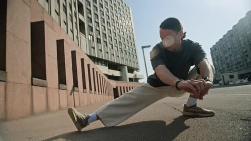 Man Stretches Urban Outdoors on Sunny Day