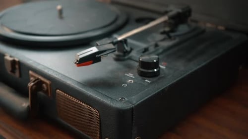Hand Adjusts Vintage Record Player Volume Knob