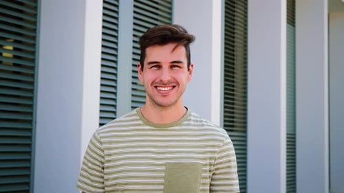 Cheerful Man Smiling Confidently in Urban Setting
