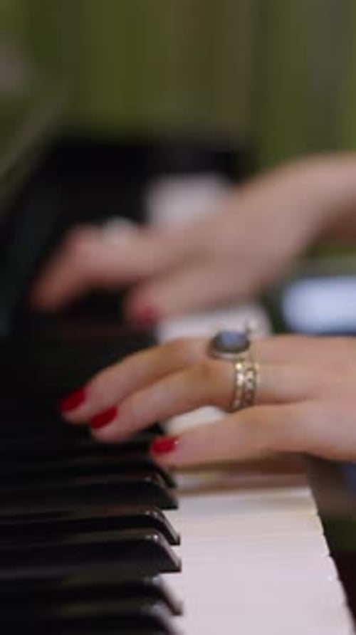 Woman's Hands Playing Piano Keys Close-Up