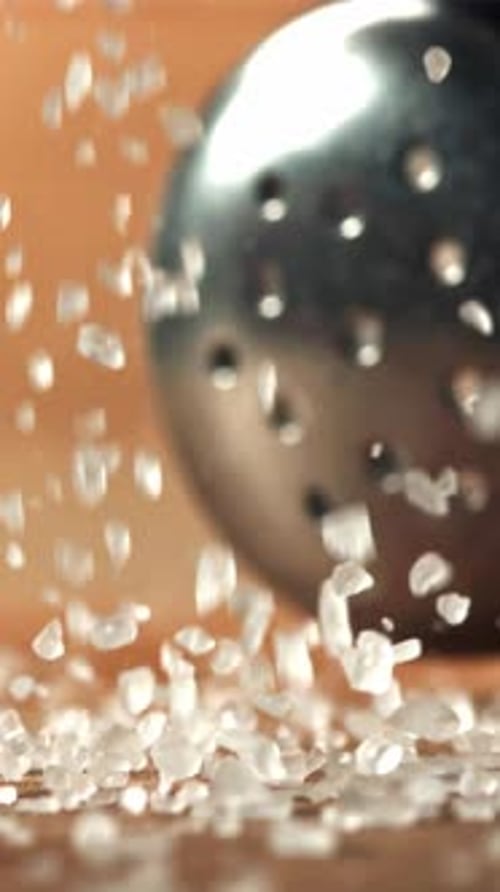 Falling Salt Crystals on a Wooden Table Macro Shot Filmed on a Highspeed Camera at 1000 Fps