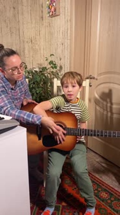 Boy Taking Guitar Lessons at Home