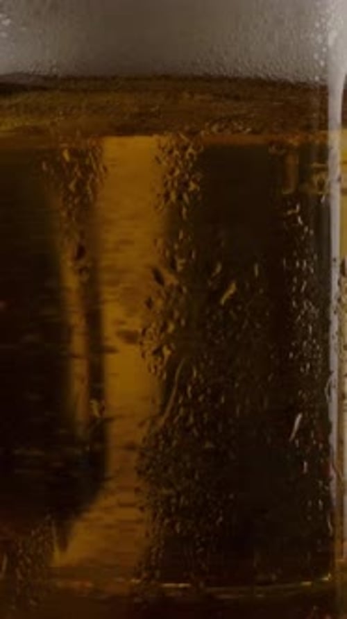 Vertical of Cold Beer in Wet Cups