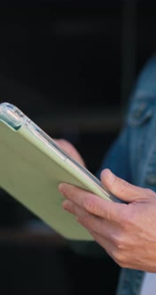 Man Using Tablet Device for Work in Studio