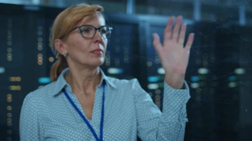 In the Modern Data Center: Portrait of Female IT Technician Working With Touch Screen Device, Doing