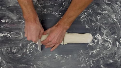 Man Hands Cut Raw Dough on the Table Handmade Cooking Top View