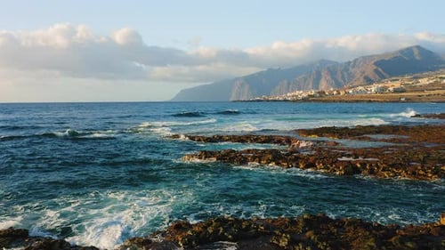 Empty Rocky Volcanic Beach of Atlantic Ocean in the Soft Morning Light Flying Low Over the Breaking