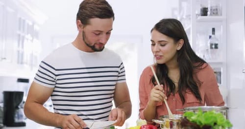 Happy Couple Prepares Food Together in Bright Kitchen