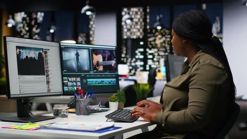 Portrait of Black Woman Video Editor Working with Dual Monitors in Agency