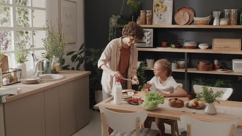 Woman Prepares Food with Child at Home