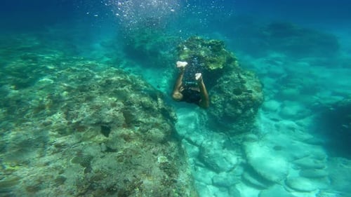 Man Diver Snorkeling Swimming in Blue Sea Underwater Near Coral Reef