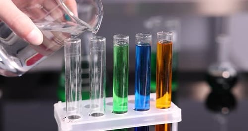 Adding Clear Liquid to Test Tubes with Colored Solutions