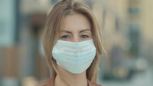 Close-Up Portrait of Modern Casual Young One Woman Wearing Protective Medical Face
