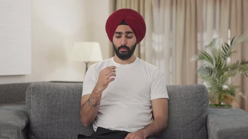 Man in Turban Taking Temperature, Feeling Sick