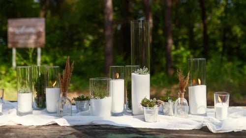 Wedding Party Banquet Outdoors in Forest Dining Table Decorated in Boho Style with Candles White
