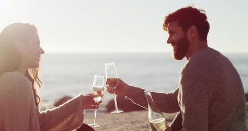 Couple with champagne glass on picnic at beach, celebration of love on holiday date