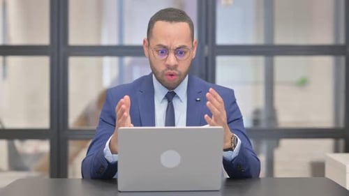 Businessman Frustrated with Computer in Bright Office