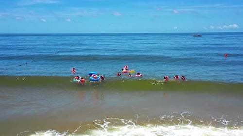 Aerial Top view of a transparent blue sea with beautiful waves at sunny day in summer. air of ocean