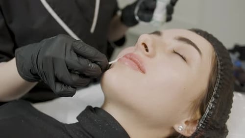 Woman Receiving Lip Treatment at Beauty Clinic