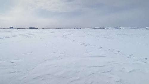 Snowy Expanse of Ice Field Under Overcast Sky